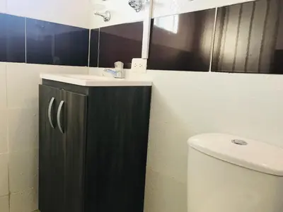 a bathroom with a sink and a toilet at La Luna by JR in Mariquita