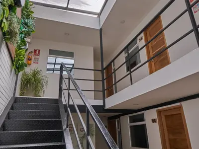 a staircase in a house with a window at Stanza Hotel Medellin in Medellín