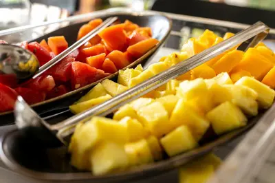 a display of fruits and vegetables on a buffet at El Rio Hotel in Doradal