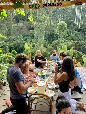 a group of people sitting around a table eating at Creo Ecolodge Jardín in Jardin