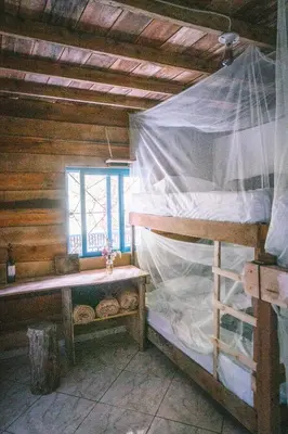 a bedroom with two bunk beds and a window at Creo Ecolodge Jardín in Jardin
