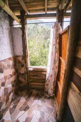 a window in a room with a view of a forest at Creo Ecolodge Jardín in Jardin