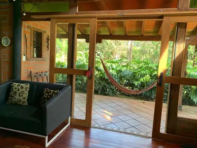 an open door to a porch with a hammock at Rancheria Loft Chalet, lago privado in Rionegro
