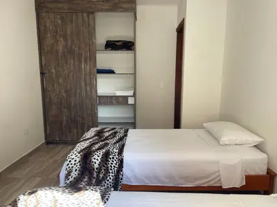a small bedroom with a bed and a closet at Apartamento cerca a cascada del Amor,Wifi in Jardin