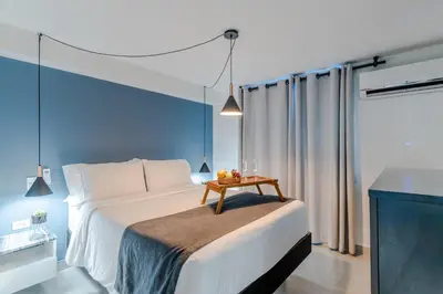 a bedroom with a bed with a table on it at Viktory Boutique Hotel in Medellín