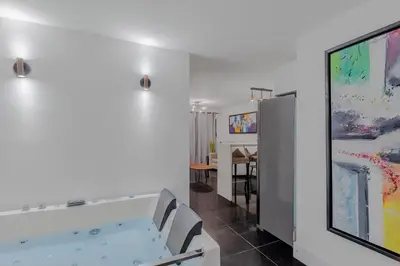 a living room with a flat screen tv and a wall at Viktory Boutique Hotel in Medellín