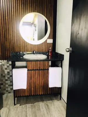 a bathroom with a sink and a mirror at Hotel & Golf Isak Aeropuerto in Rionegro