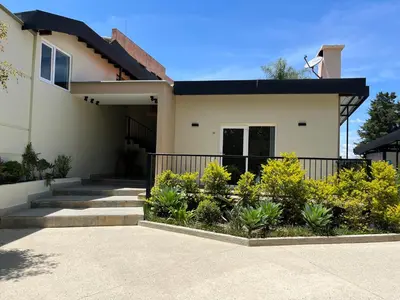 a house with stairs and plants in front of it at Hotel & Golf Isak Aeropuerto in Rionegro