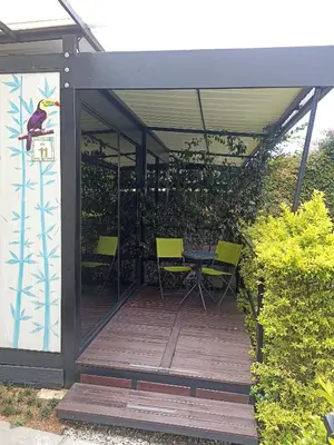a patio with a table and chairs on a deck at Hotel & Golf Isak Aeropuerto in Rionegro