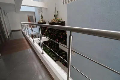 a balcony in a building with plants on it at HOTEL PORTÓN ESTADIO in Medellín