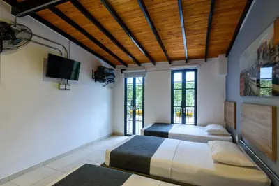 a bedroom with two beds and a flat screen tv at Med la palma in Medellín