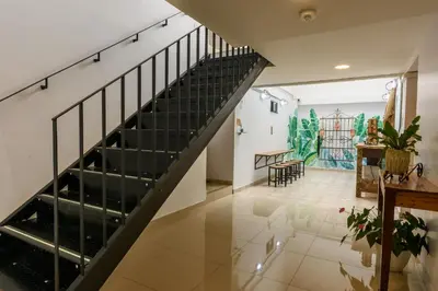 a staircase in a house with a table and chairs at Med la palma in Medellín