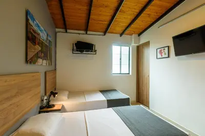 a bedroom with a bed and a flat screen tv at Med la palma in Medellín