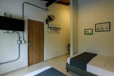 a bedroom with a bed and a tv and a door at Med la palma in Medellín