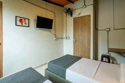 a room with a bed and a flat screen tv at Med la palma in Medellín