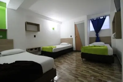 a hotel room with two beds and a window at HOTEL MANAGER OBELISK in Medellín