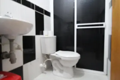 a bathroom with a toilet and a sink at HOTEL MANAGER OBELISK in Medellín