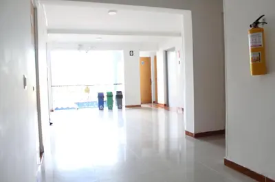 an empty hallway with a large window in a building at HOTEL MANAGER OBELISK in Medellín
