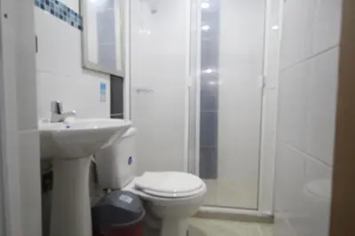 a bathroom with a toilet and a sink and a shower at HOTEL MANAGER OBELISK in Medellín