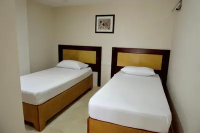 two beds in a small room with at Hotel San Pedro del Fuerte in Medellín