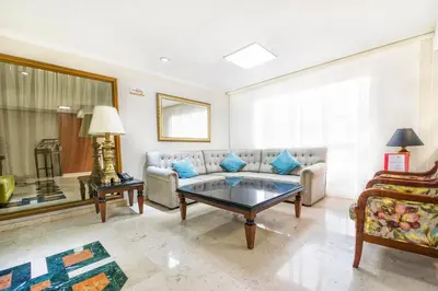 a living room with a couch and a table at Hotel San Pedro del Fuerte in Medellín