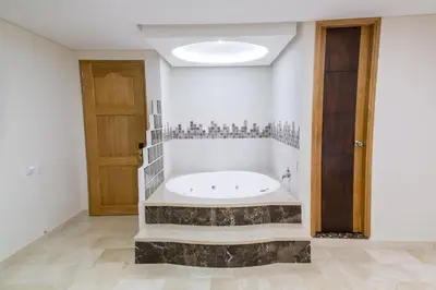 a large bathroom with a tub in the middle of a room at Hotel San Pedro del Fuerte in Medellín