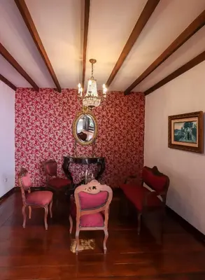 a room with a table and chairs and a mirror at Casa Lola Hotel Boutique in Salamina