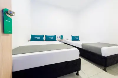 two beds sitting next to each other in a room at Ayenda Panamericana in Manizales