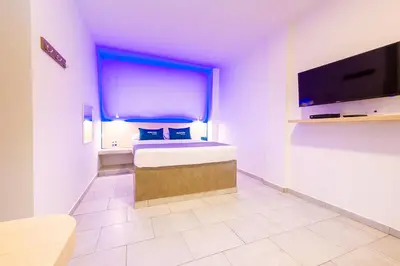 a bedroom with a bed with a large window at Ayenda Panamericana in Manizales