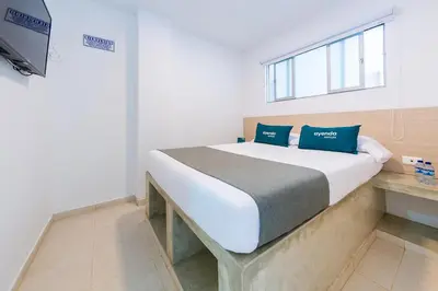 a bedroom with a bed and a television in it at Ayenda Panamericana in Manizales