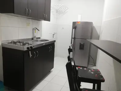 a small kitchen with a sink and a refrigerator at APARTA ESTUDIO 7051 in Medellín