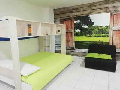 a bedroom with a bunk bed and a chair at APARTA ESTUDIO 7051 in Medellín