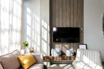 a living room with a couch and a television at Factory Lofts Hotel in Medellín