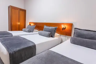 two beds in a hotel room with two pillows at Hotel Sauces del Estadio in Medellín
