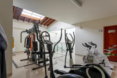 a gym with several cardio machines in a room at Hotel Sauces del Estadio in Medellín