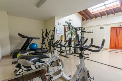 a row of exercise bikes in a gym at Hotel Sauces del Estadio in Medellín