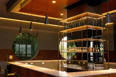 a bar with a shelf of wine bottles at Termales El Otoño in Manizales