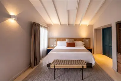 a hotel room with a bed and a table at Termales El Otoño in Manizales
