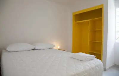 a white bed with two pillows in a bedroom at Home Aris Apartments 201 in Medellín