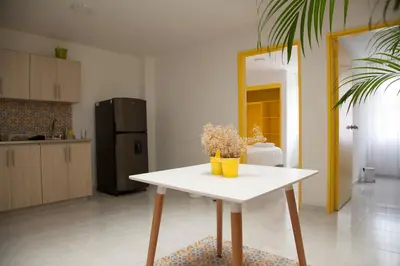 a white table in a room with a kitchen at Home Aris Apartments 201 in Medellín