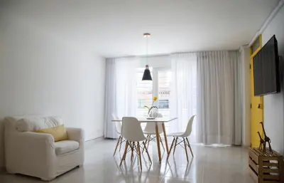 a living room with a table and a chair at Home Aris Apartments 201 in Medellín