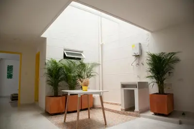 a room with a table and two plants at Home Aris Apartments 201 in Medellín