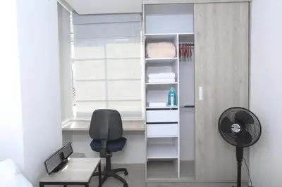 a bedroom with a desk and a chair and a window at New Studio Apartment for Two in Medellín