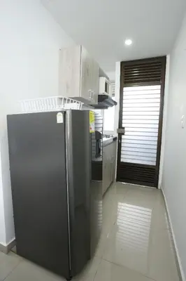 a kitchen with a stainless steel refrigerator and microwave at New Studio Apartment for Two in Medellín