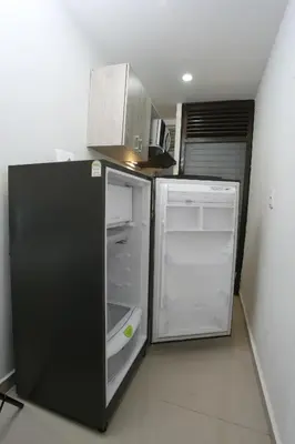 a kitchen with an open refrigerator and a microwave at New Studio Apartment for Two in Medellín