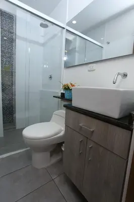 a bathroom with a toilet and a sink and a shower at New Studio Apartment for Two in Medellín