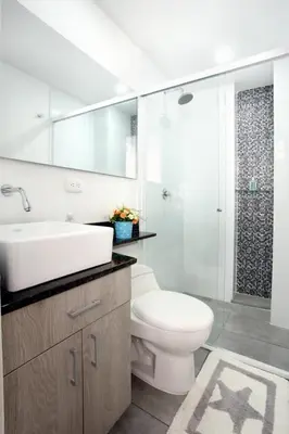 a bathroom with a toilet and a sink and a shower at New Studio Apartment for Two in Medellín