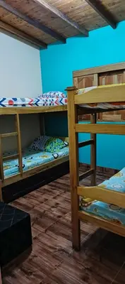 two bunk beds in a room with a blue wall at Finca campestre y recreativa los potrillos in Doradal