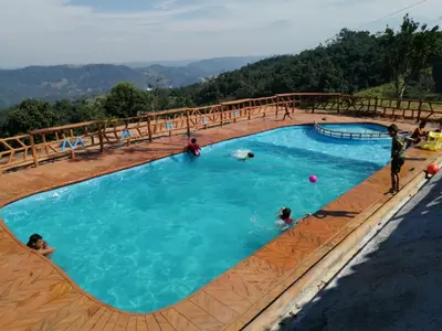 a large swimming pool with people playing in it at Finca campestre y recreativa los potrillos in Doradal