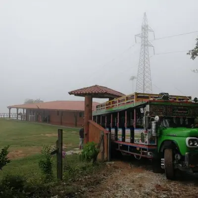 a green bus parked in front of a building at Finca campestre y recreativa los potrillos in Doradal